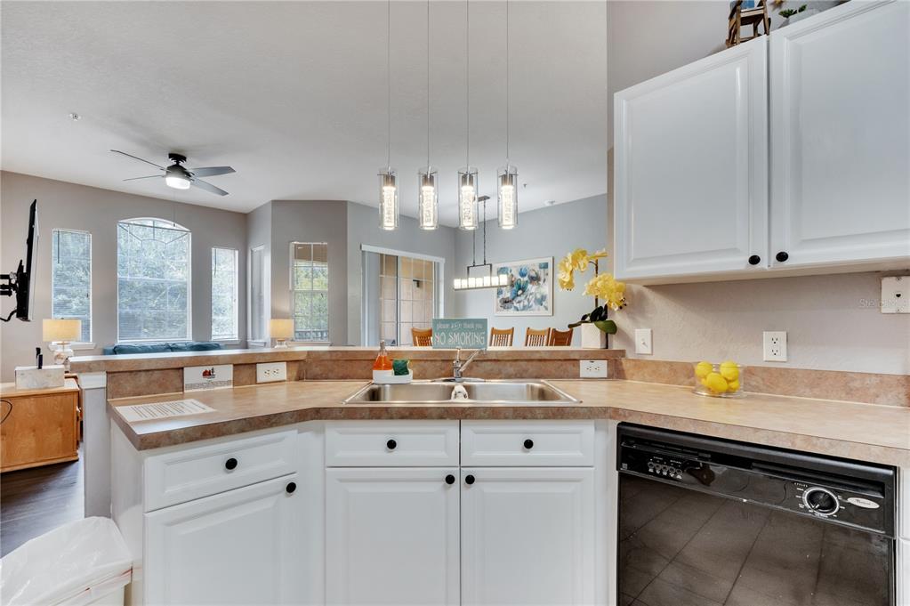 505 Terrace Ridge Circle, Unit 505 Davenport, FL 33896 - Photo 8 of 47 a kitchen with stainless steel appliances white cabinets and a sink
