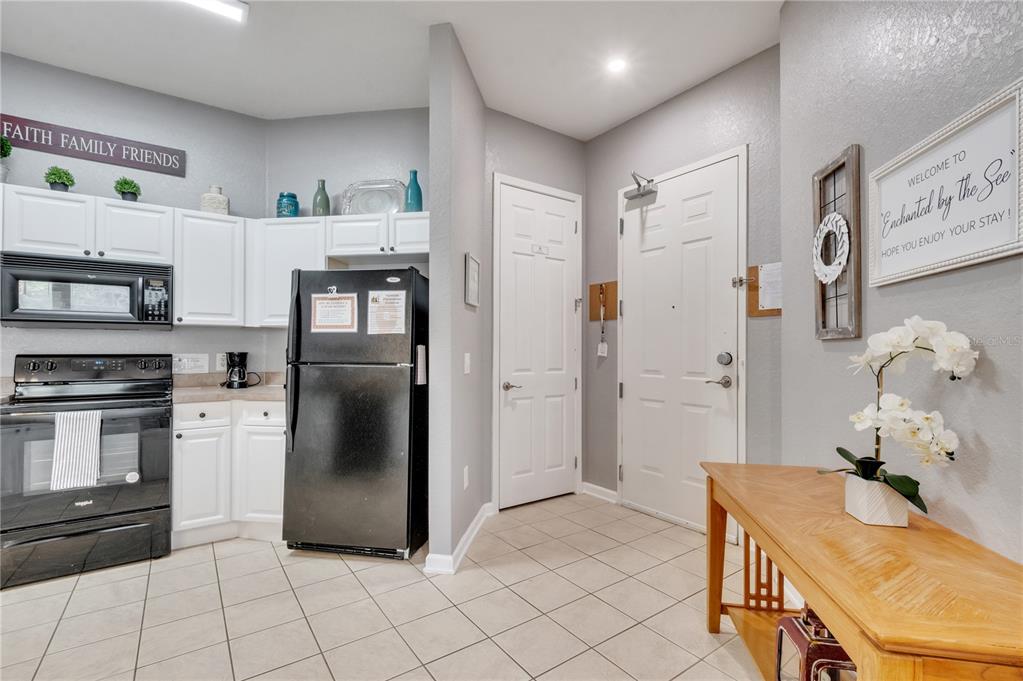 505 Terrace Ridge Circle, Unit 505 Davenport, FL 33896 - Photo 9 of 47 a kitchen with stainless steel appliances granite countertop a refrigerator and a stove top oven