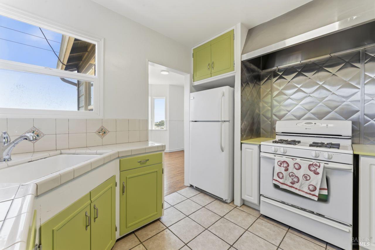 111 Altena Street San Rafael, CA 94901 - Photo 5 of 46 a kitchen with a stove a sink and a refrigerator