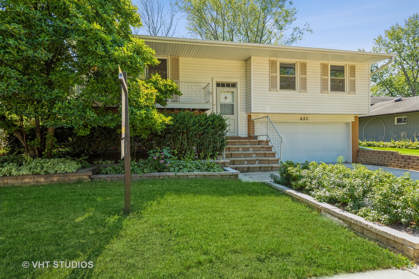 637 Sycamore Road Buffalo Grove, IL 60089 - Photo 1 of 23 a front view of a house with garden