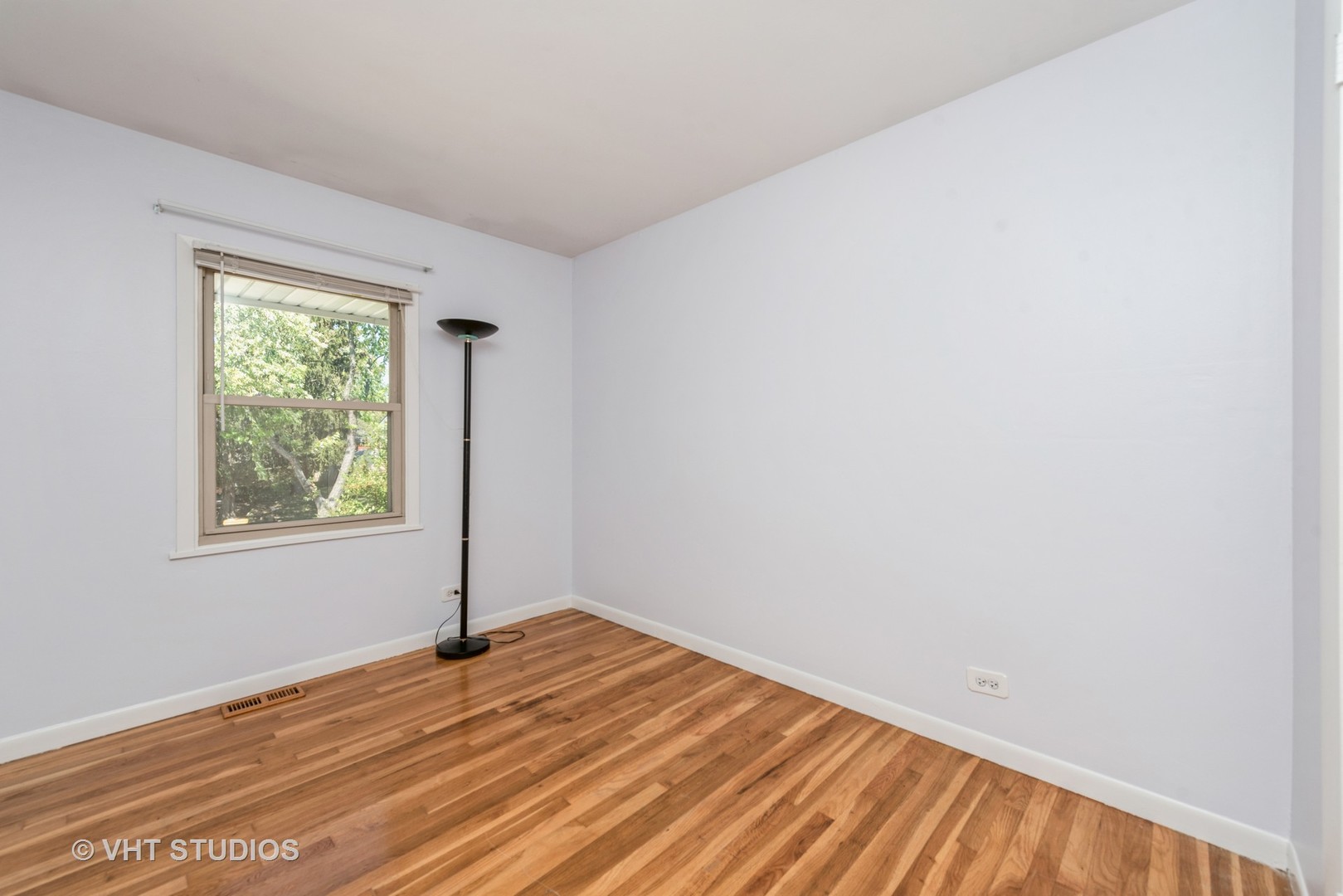 637 Sycamore Road Buffalo Grove, IL 60089 - Photo 11 of 23 a view of empty room with wooden floor and fan