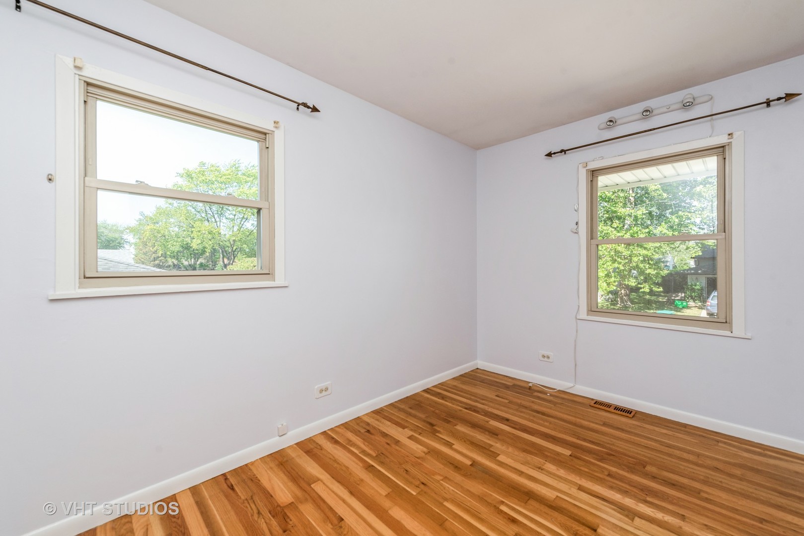 637 Sycamore Road Buffalo Grove, IL 60089 - Photo 12 of 23 a view of a room with wooden floor and a window