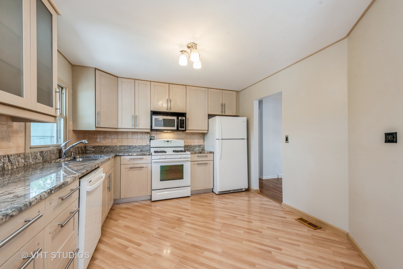 637 Sycamore Road Buffalo Grove, IL 60089 - Photo 6 of 23 a kitchen with white cabinets and white appliances