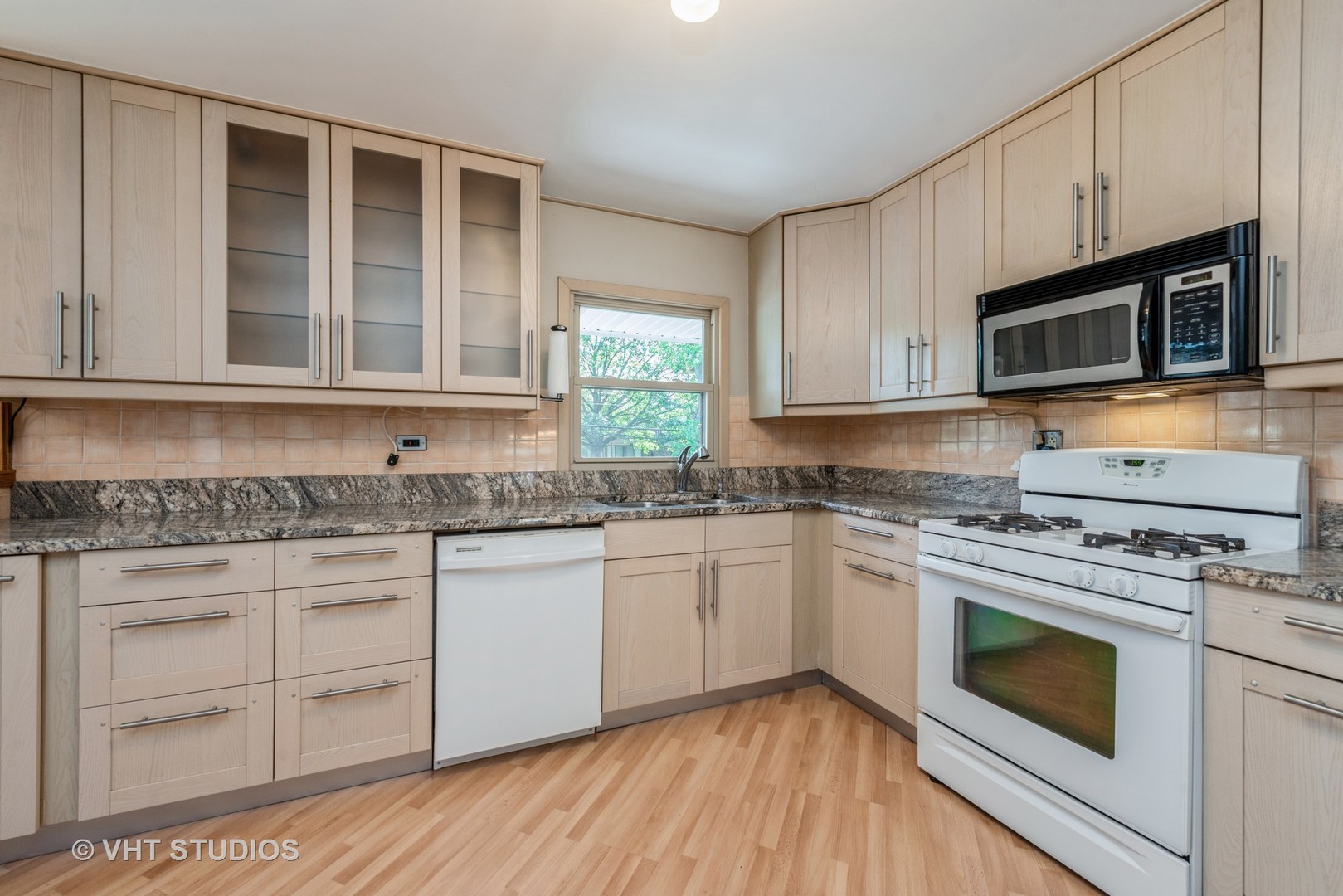 637 Sycamore Road Buffalo Grove, IL 60089 - Photo 7 of 23 a kitchen with granite countertop wooden cabinets stainless steel appliances and a sink