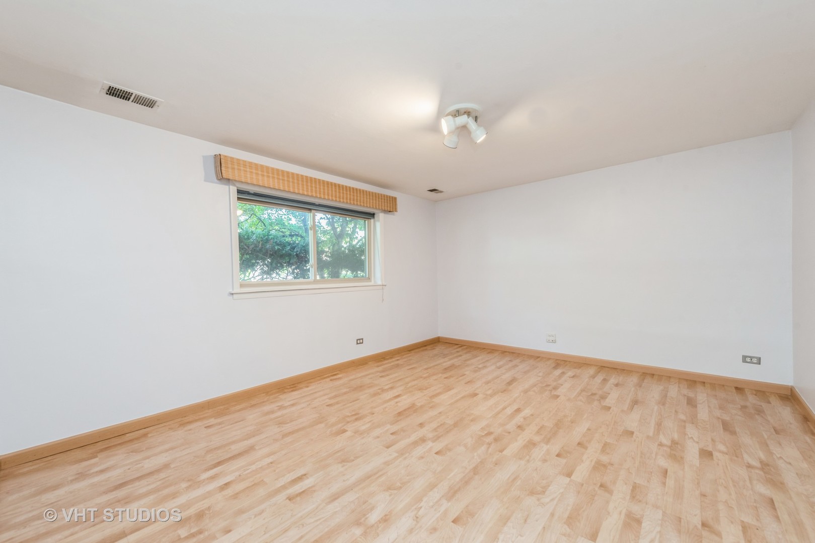 637 Sycamore Road Buffalo Grove, IL 60089 - Photo 9 of 23 an empty room with wooden floor and windows