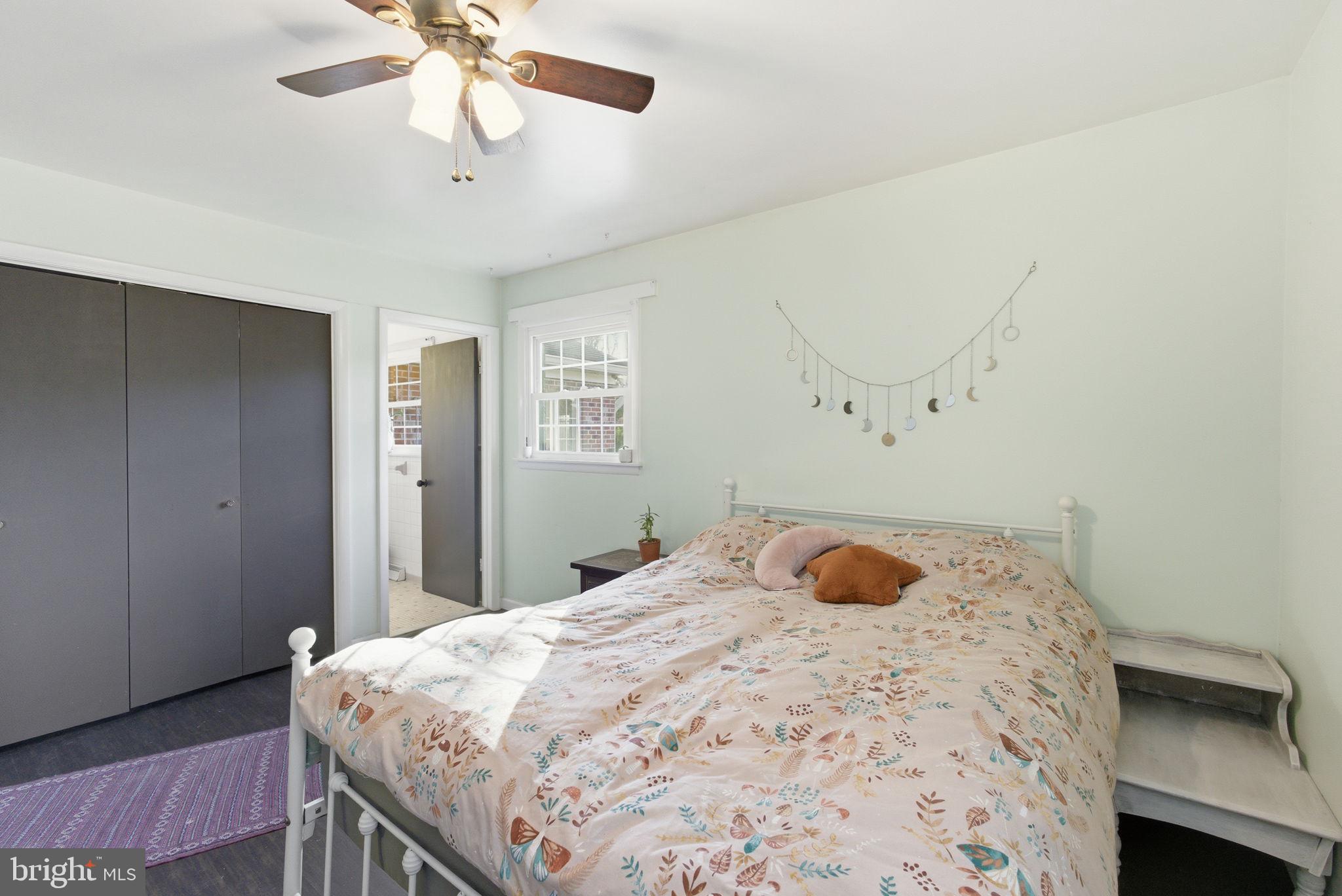 9769 Trinity Church Road Charlotte Hall, MD 20622 - Photo 18 of 61 a bedroom with a bed and a chandelier