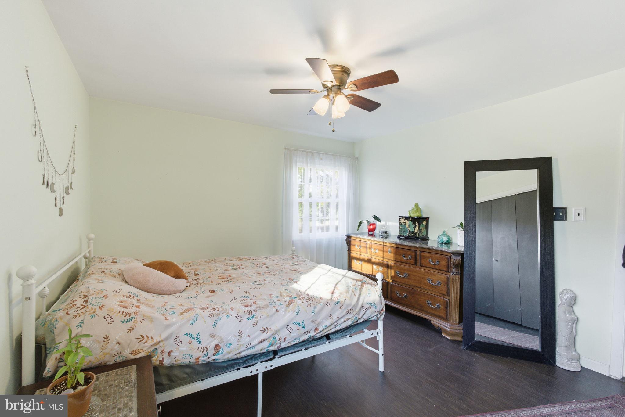 9769 Trinity Church Road Charlotte Hall, MD 20622 - Photo 19 of 61 a bedroom with a bed and wooden floor