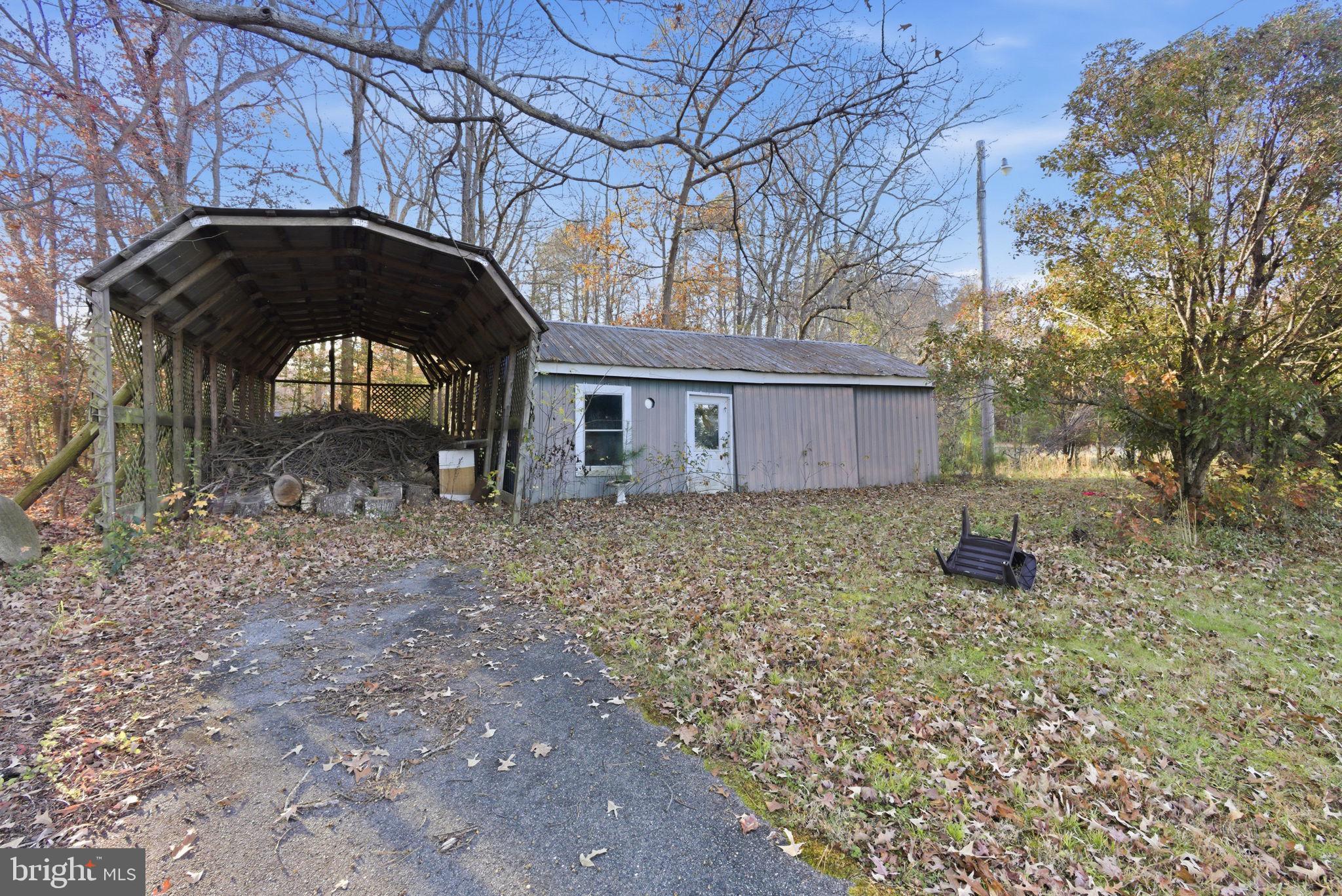9769 Trinity Church Road Charlotte Hall, MD 20622 - Photo 55 of 61 a backyard of a house with table and chairs