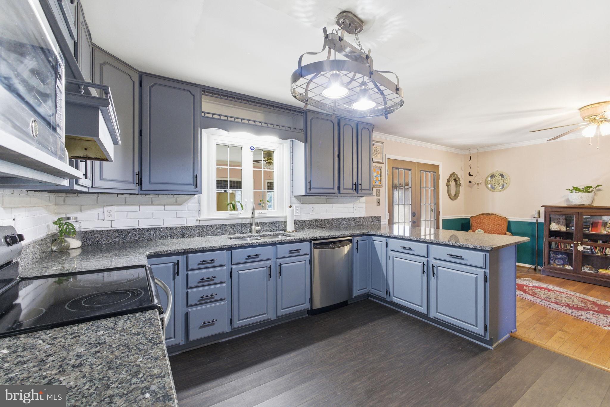 9769 Trinity Church Road Charlotte Hall, MD 20622 - Photo 8 of 61 a kitchen with stainless steel appliances granite countertop a sink and cabinets