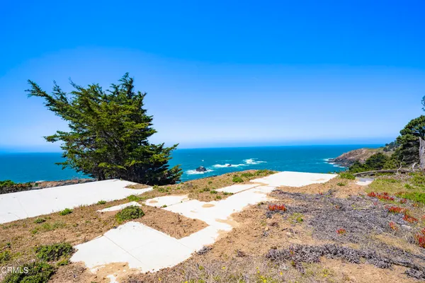 a view of ocean with a building in the background