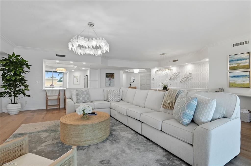 445 Dockside Drive, Unit B202 Naples, FL 34110 - Photo 12 of 50 a living room with furniture and a chandelier