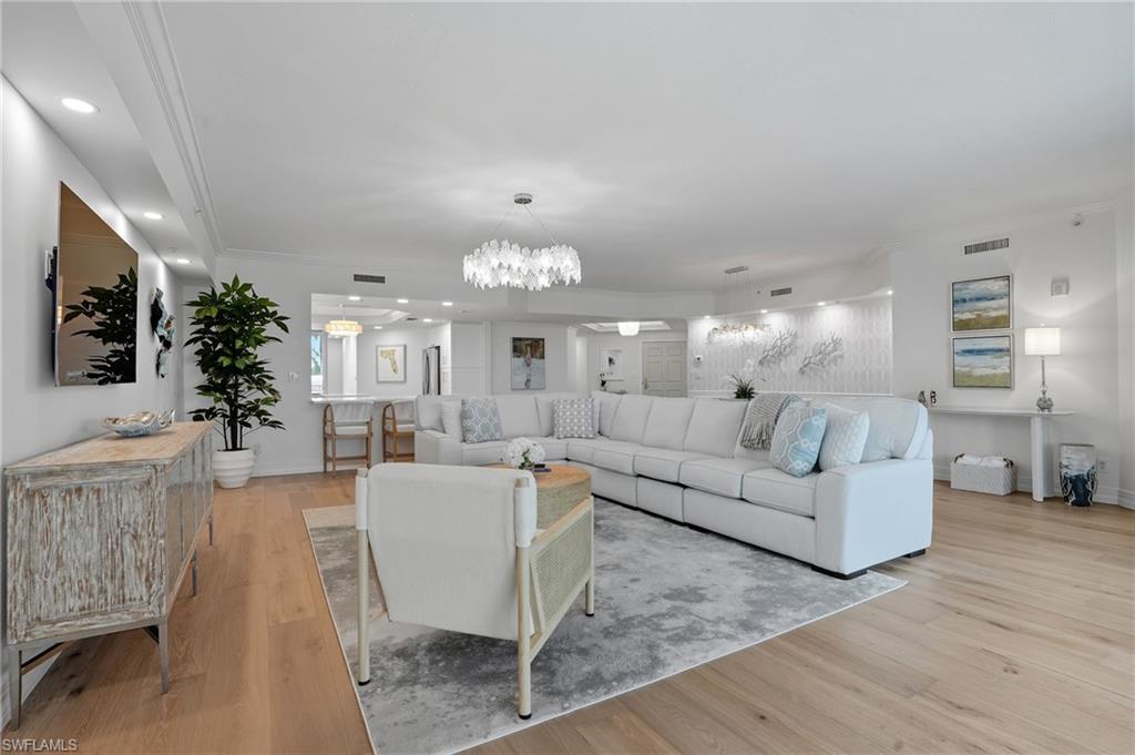 445 Dockside Drive, Unit B202 Naples, FL 34110 - Photo 13 of 50 a living room with furniture and a chandelier