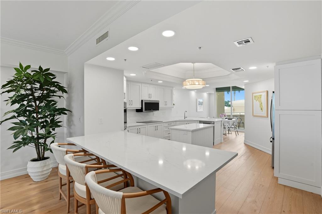 445 Dockside Drive, Unit B202 Naples, FL 34110 - Photo 14 of 50 Reconfigured Kitchen - Now Featuring a Seamless Open Concept Layout with a Bar Area.
