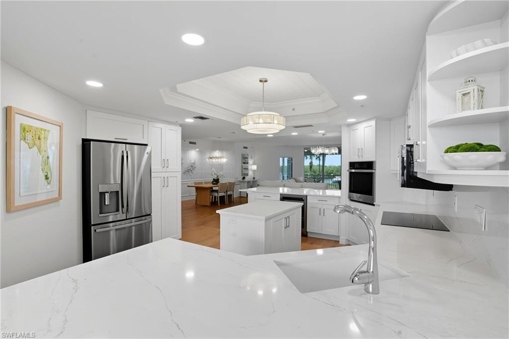 445 Dockside Drive, Unit B202 Naples, FL 34110 - Photo 16 of 50 a kitchen with refrigerator and furniture