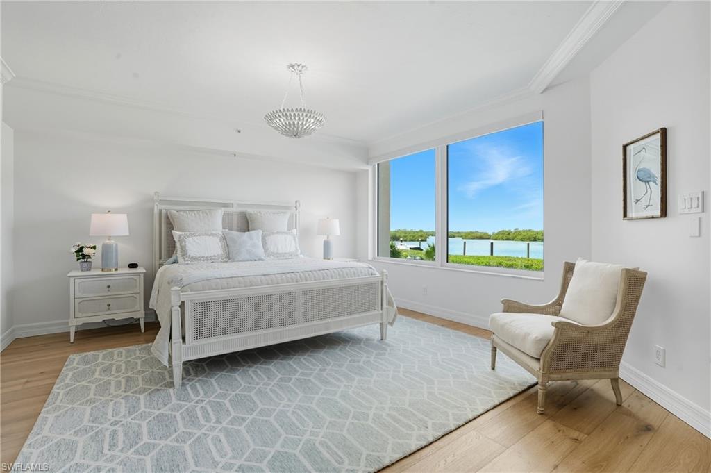 445 Dockside Drive, Unit B202 Naples, FL 34110 - Photo 24 of 50 a bedroom with a bed chair and window
