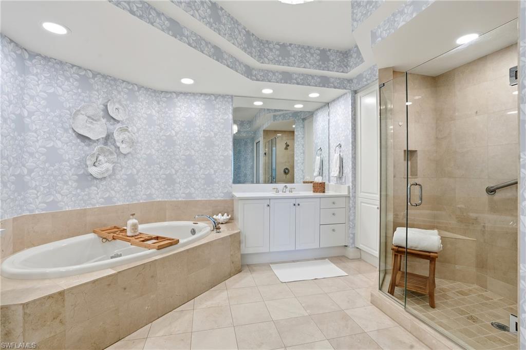 445 Dockside Drive, Unit B202 Naples, FL 34110 - Photo 27 of 50 a large spacious bathroom with a tub a double vanity sink a mirror a shower and a bathtub