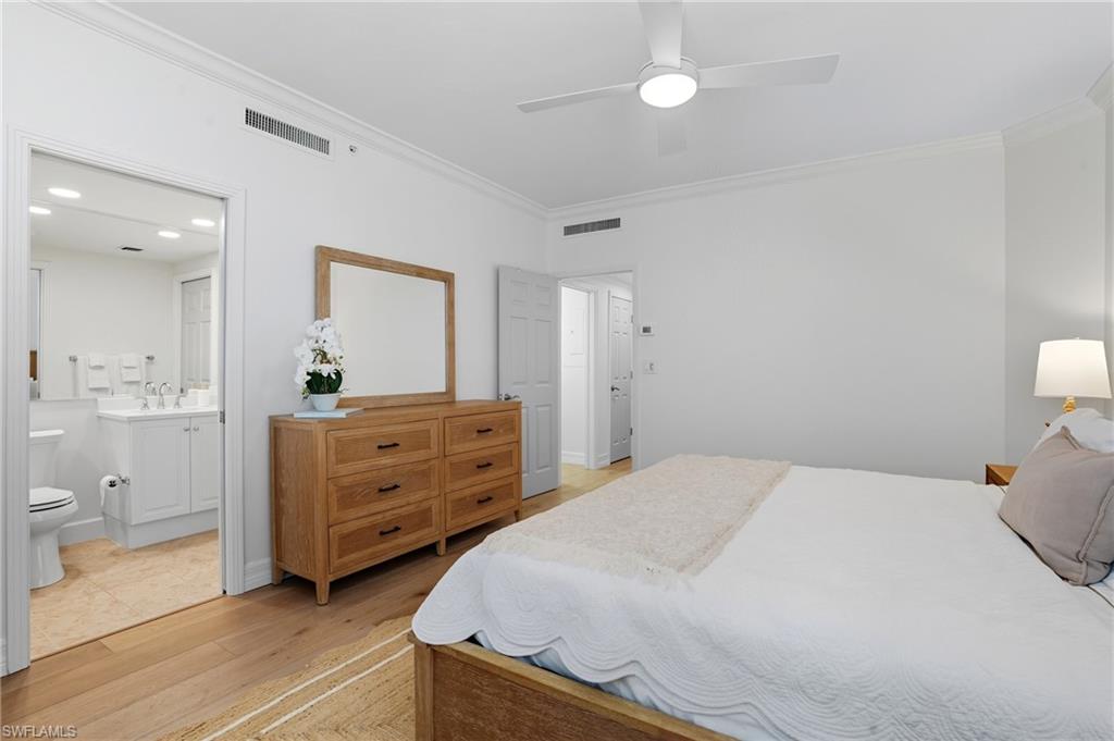 445 Dockside Drive, Unit B202 Naples, FL 34110 - Photo 31 of 50 a bedroom with a bed and a dresser