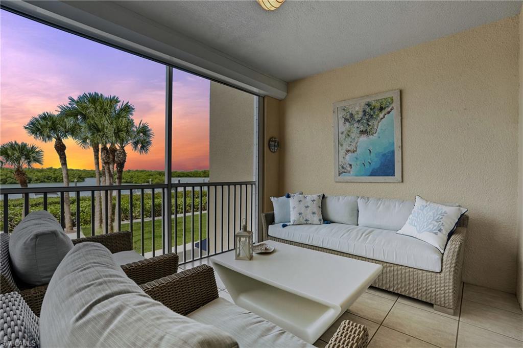 445 Dockside Drive, Unit B202 Naples, FL 34110 - Photo 34 of 50 a living room with furniture and a potted plant