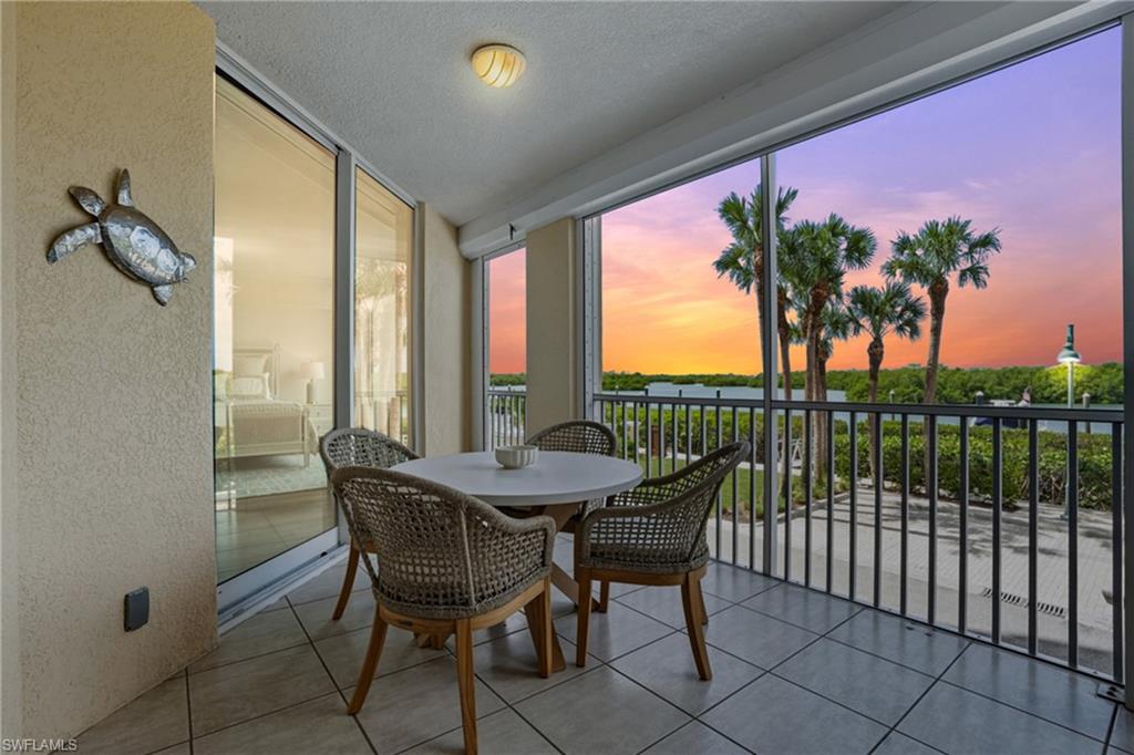 445 Dockside Drive, Unit B202 Naples, FL 34110 - Photo 35 of 50 a view of a balcony with furniture and a potted plant
