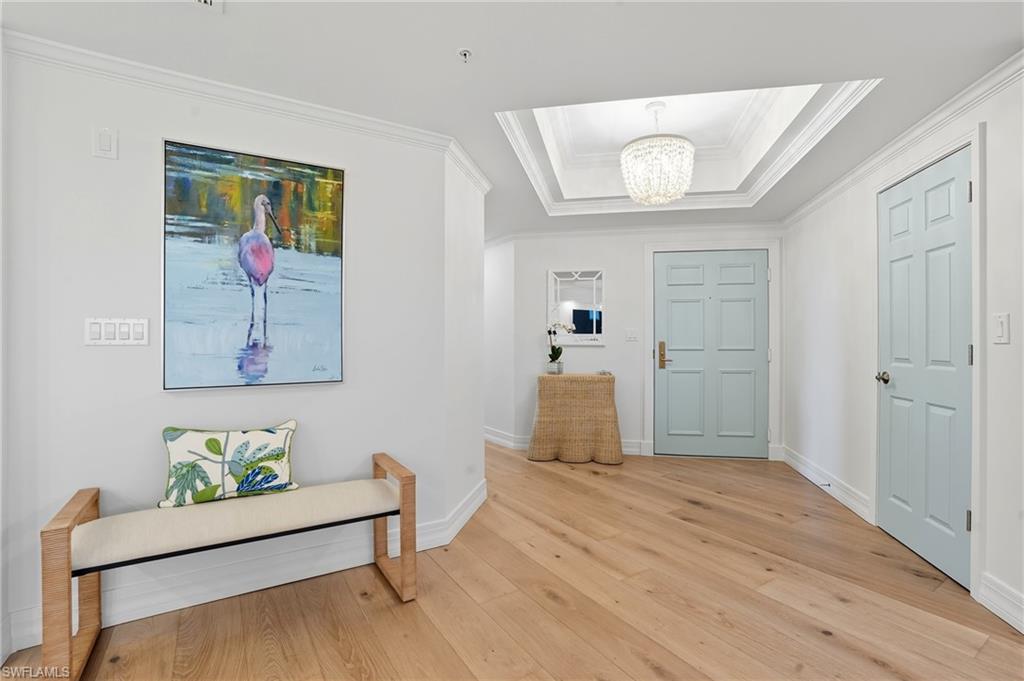 445 Dockside Drive, Unit B202 Naples, FL 34110 - Photo 4 of 50 a living room with furniture and a wooden floor