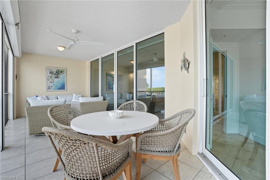 445 Dockside Drive, Unit B202 Naples, FL 34110 - Photo 41 of 50 a dining room with furniture window and outside view