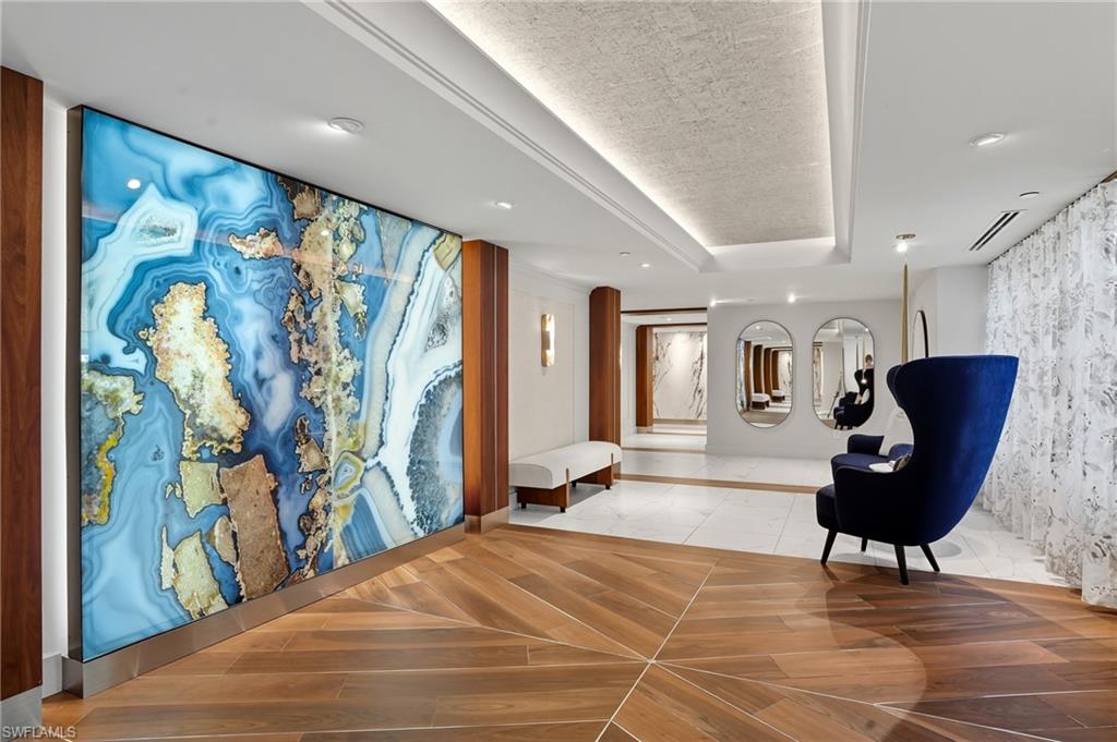 445 Dockside Drive, Unit B202 Naples, FL 34110 - Photo 44 of 50 a living room with furniture and a painting on the wall