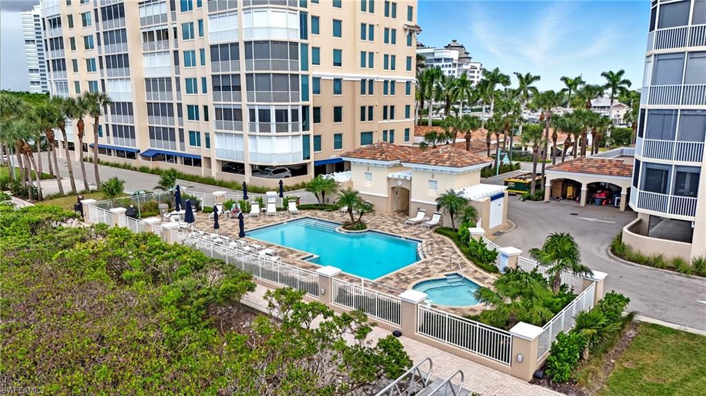 445 Dockside Drive, Unit B202 Naples, FL 34110 - Photo 47 of 50 a view of a tall building with a yard and plants