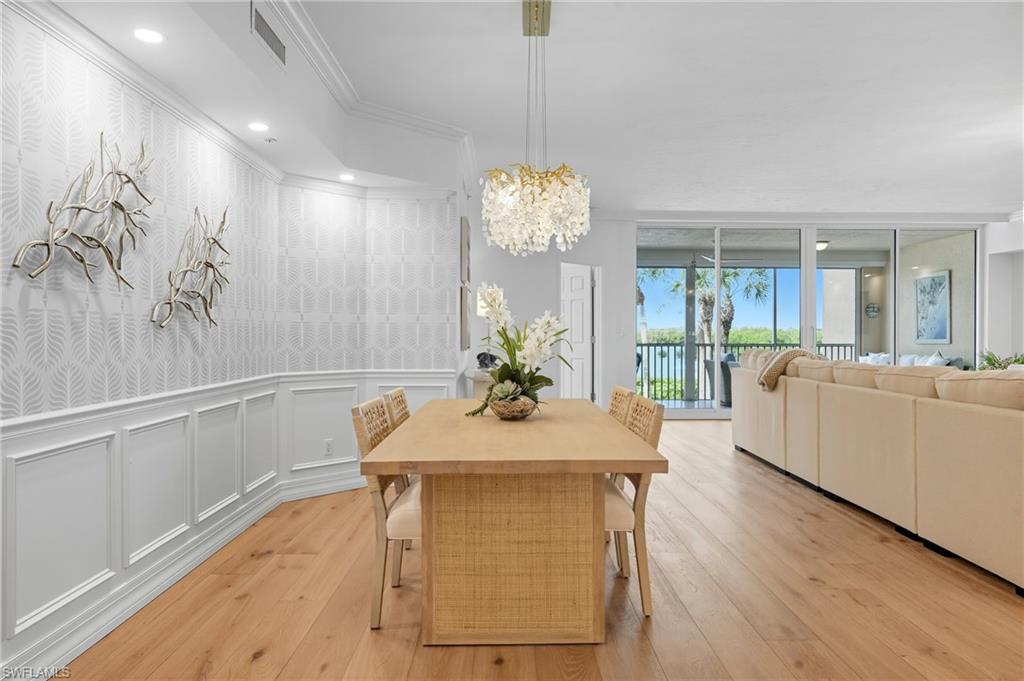 445 Dockside Drive, Unit B202 Naples, FL 34110 - Photo 9 of 50 a view of a dining room with furniture and wooden floor