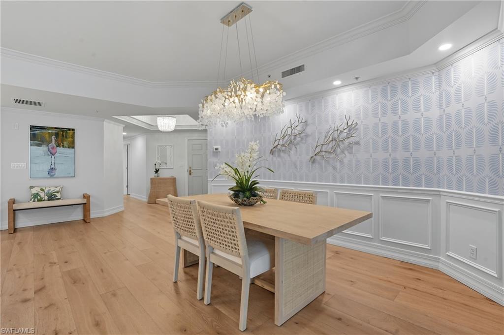 445 Dockside Drive, Unit B202 Naples, FL 34110 - Photo 10 of 50 a view of a dining room with furniture and wooden floor