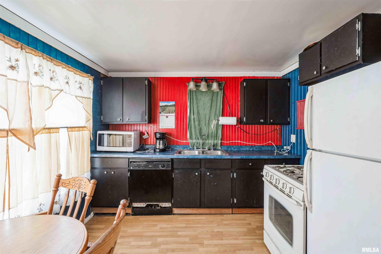 305 East 3rd Street Mineral, IL 61344 - Photo 17 of 22 a kitchen with a sink appliances and cabinets