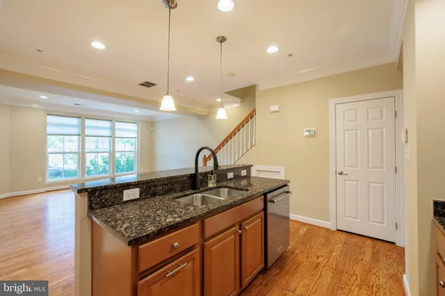 a kitchen with a sink a counter top space and a window