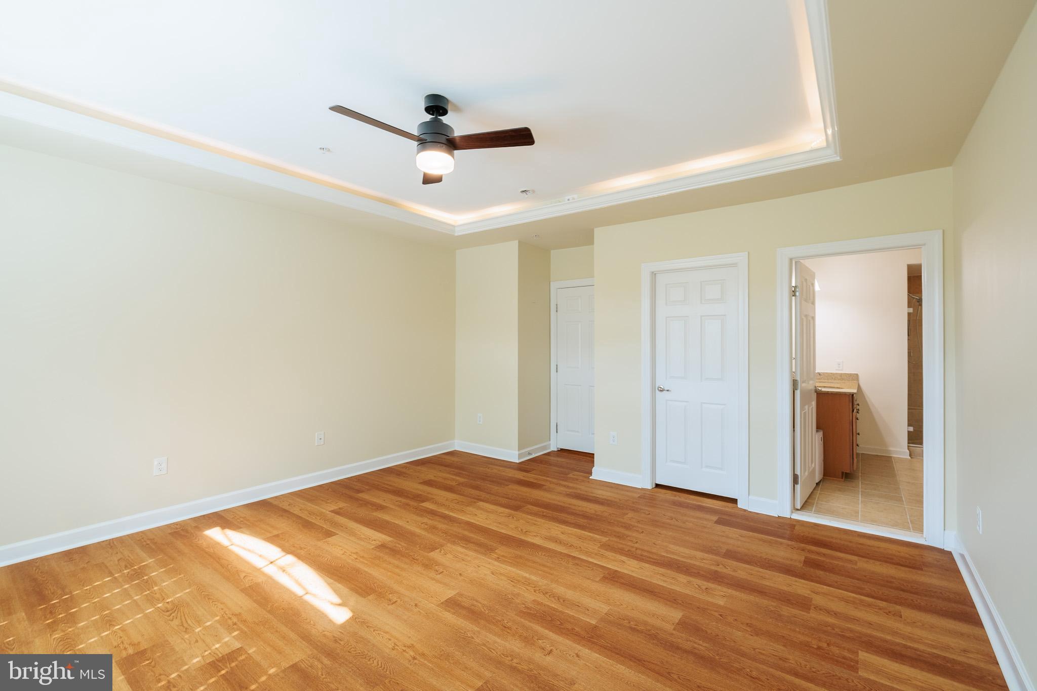 256 Urban Avenue, Unit 256 Gaithersburg, MD 20878 - Photo 23 of 41 a view of empty room with wooden floor and ceiling fan