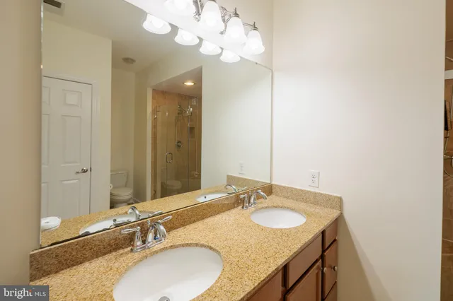 a bathroom with a shower and a glass door