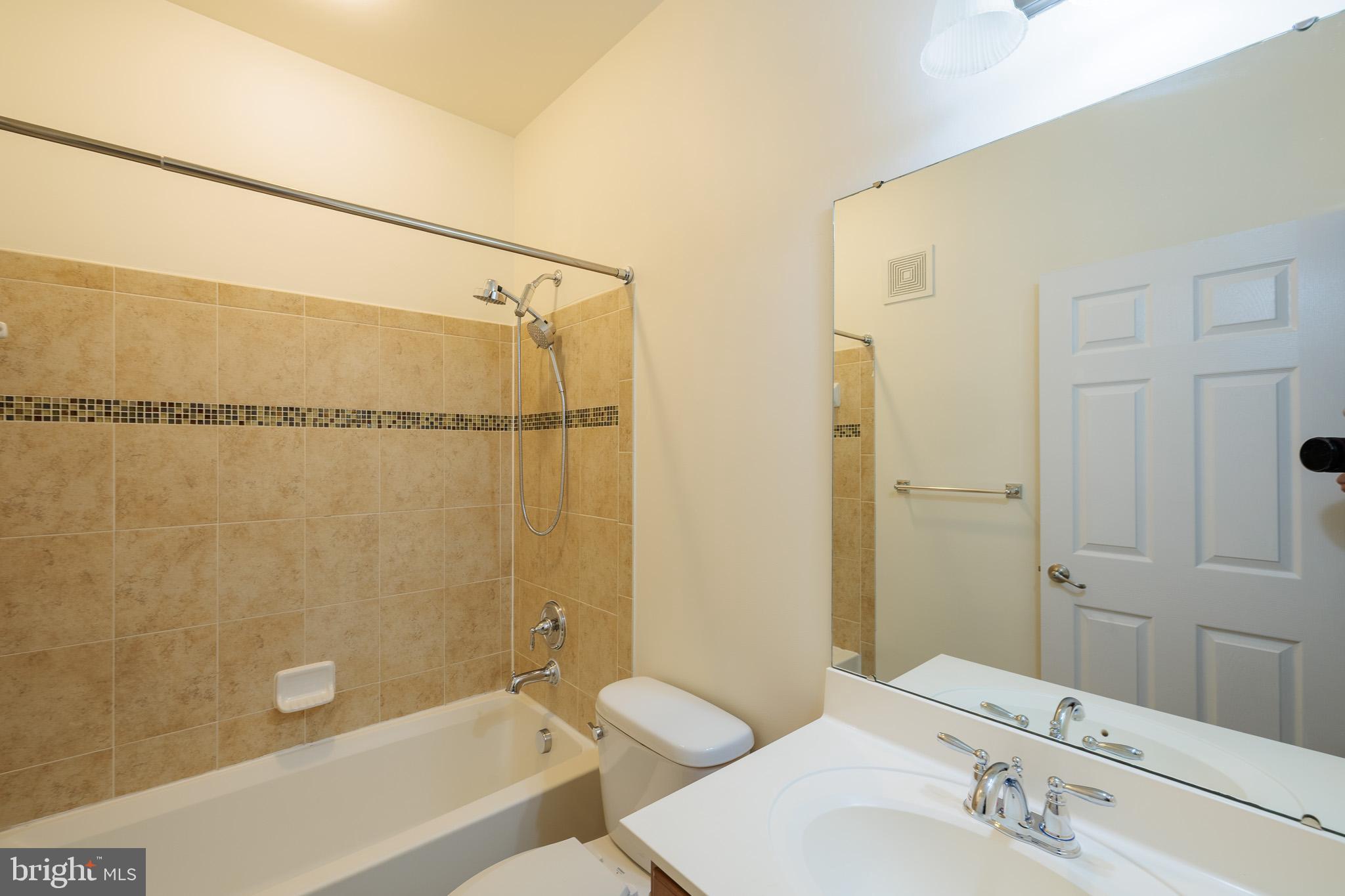 256 Urban Avenue, Unit 256 Gaithersburg, MD 20878 - Photo 31 of 41 a bathroom with a shower curtain a sink and a mirror