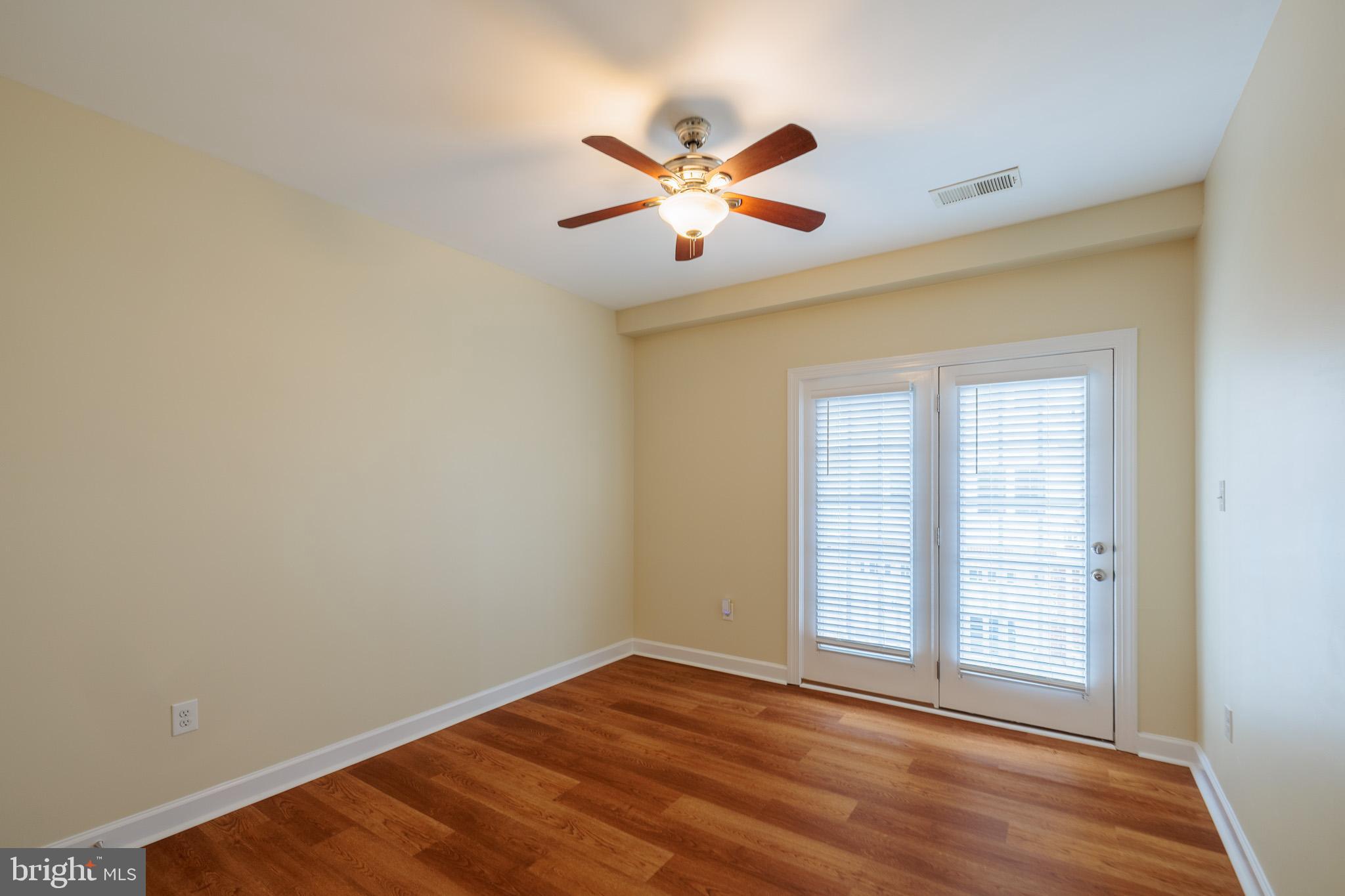 256 Urban Avenue, Unit 256 Gaithersburg, MD 20878 - Photo 36 of 41 a view of an empty room with wooden floor and a window