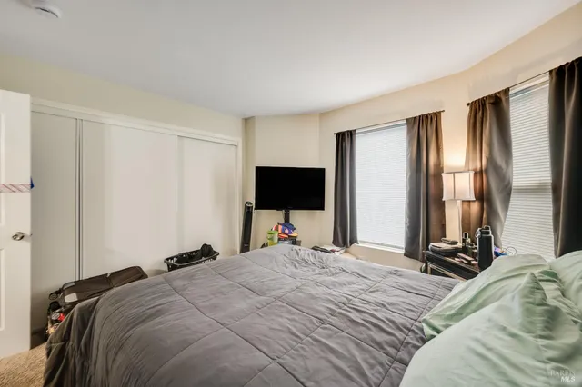 a bedroom with a bed and a flat screen tv