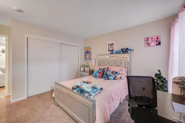 a bedroom with a bed and a dresser in it