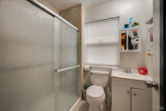a bathroom with a toilet sink and shower