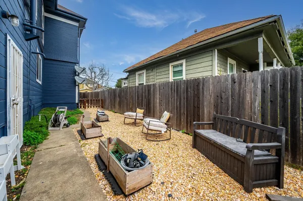 a view of a lounge chairs in the back yard of the house