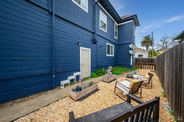 a view of a patio with couches table and chairs and potted plants
