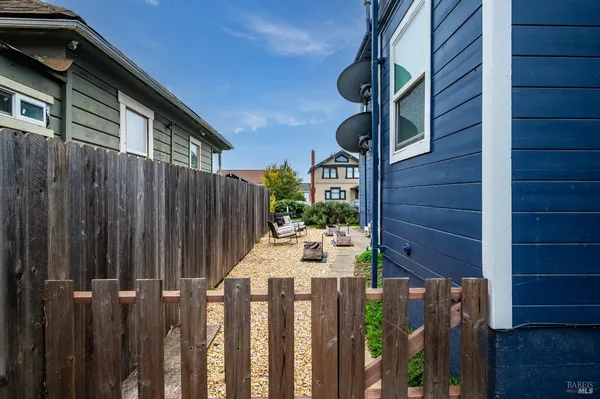 a view of a house with wooden fence