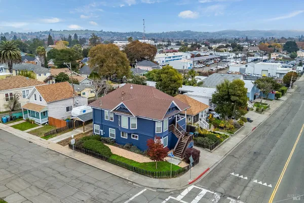 an aerial view of multiple houses with yard