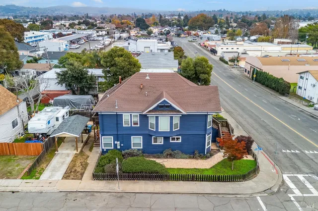 an aerial view of a house with garden space and street view
