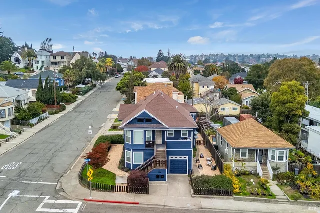 a aerial view of a houses with a yard