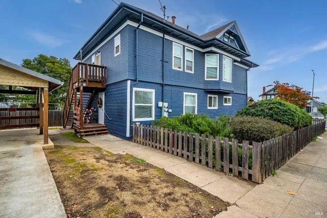a view of a house with wooden fence