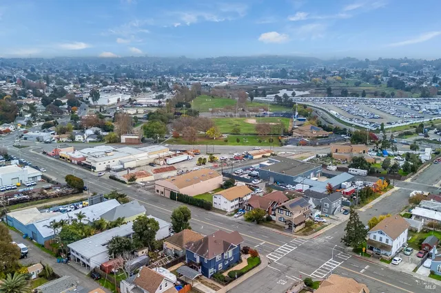 an aerial view of a house with a big yard