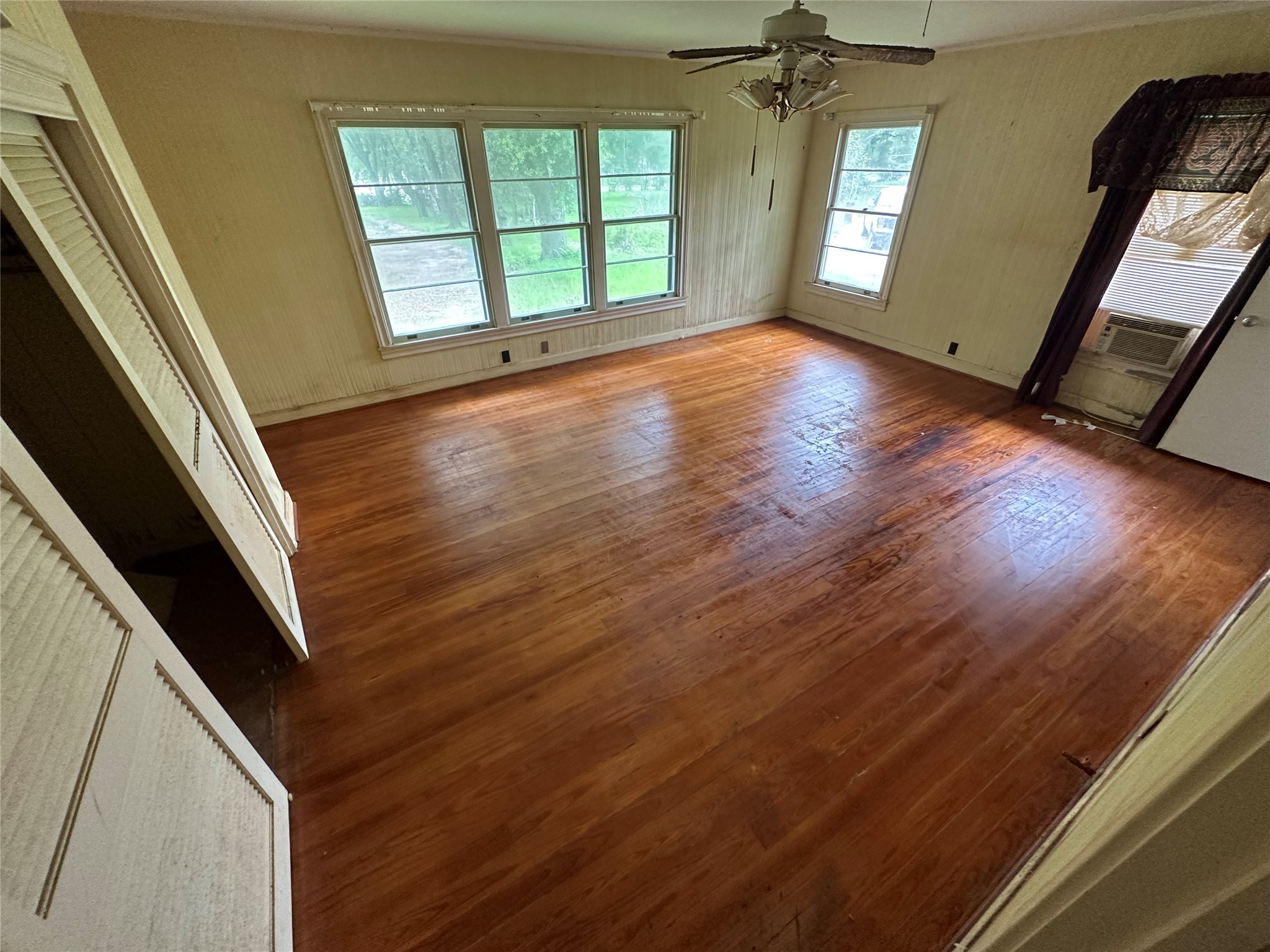 326 Prospect Drive Trinity, TX 75862 - Photo 12 of 22 a view of an empty room with wooden floor and a window
