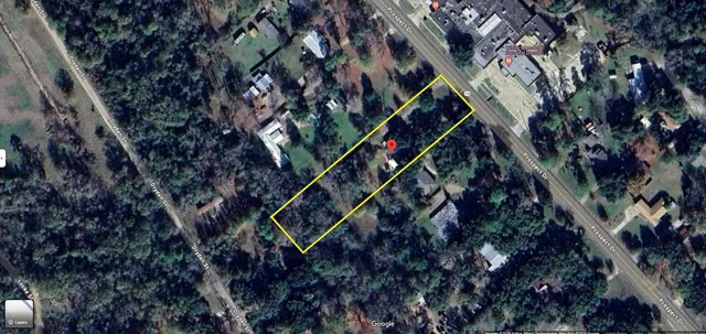 a backyard of a house with lots of plants and trees