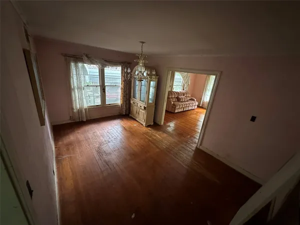 a view of a room with window wooden floor and chandelier