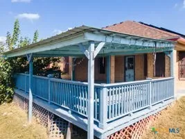 a view of a house with wooden fence